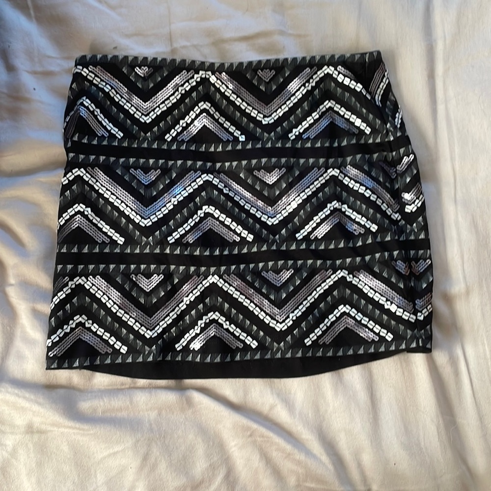 Express mini skirt. Size small. Black with silver patterns.